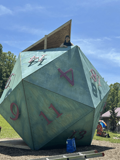 Thirteen foot tall twenty-sided wooden structure painted like a D20 die
