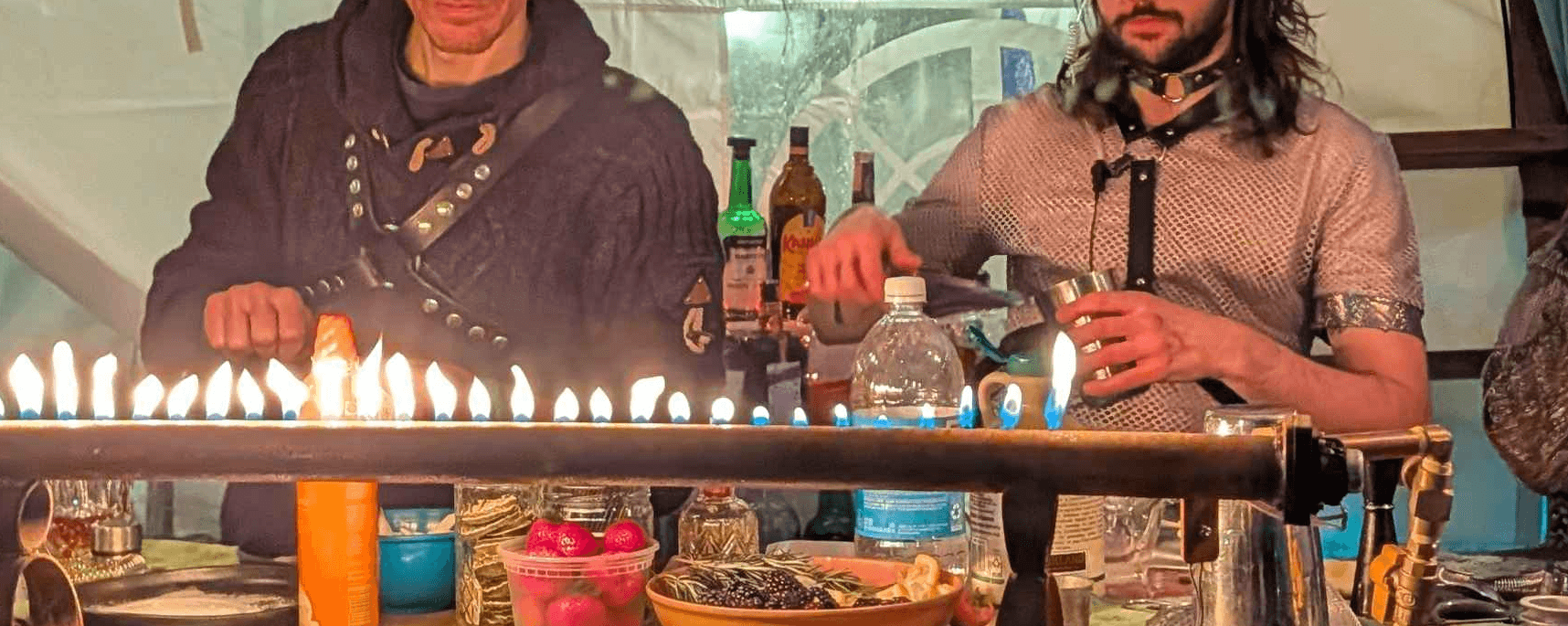 Colorful bar with fire display and bartenders behind the bar